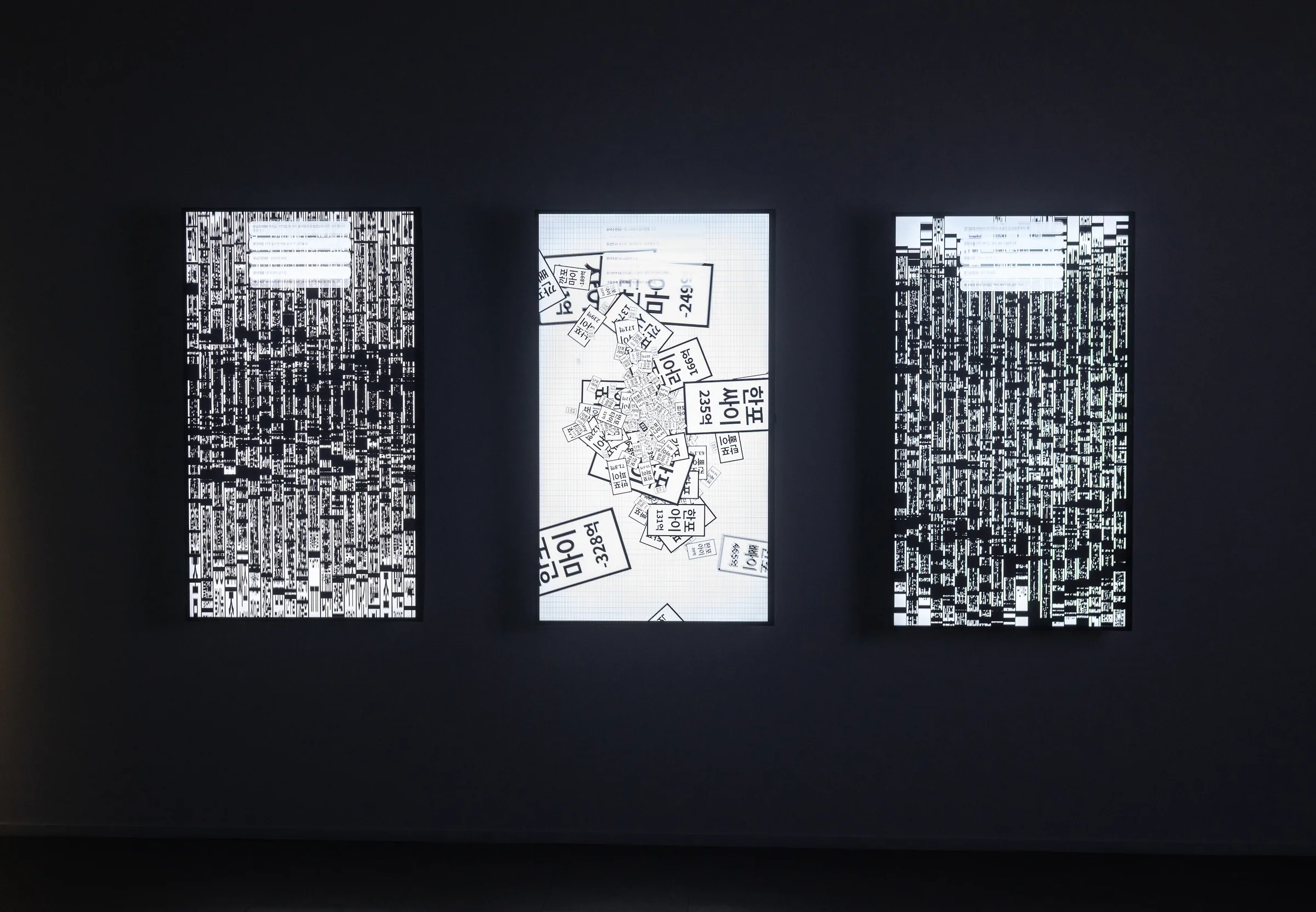 Jeanyoon Choi, ∫ (Banpo-Xism) (2026) — three TV panels showing text and image fields; the labels 'Banpo' and 'Xi' scatter across the plane.